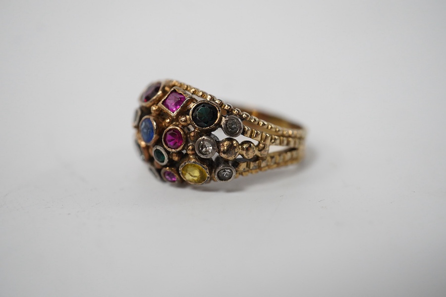 A 1940's continental yellow metal and multi gem set cluster dress ring, size P, gross weight 6.6 grams. Condition - poor to fair